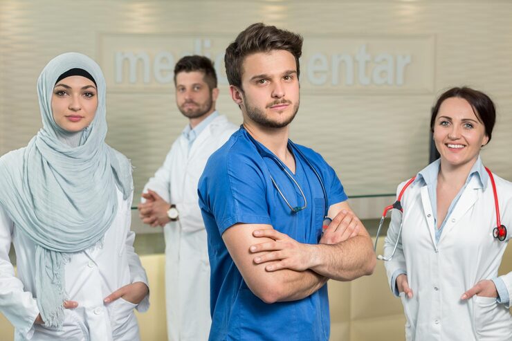 Male doctor leading a group of healthcare professionals.