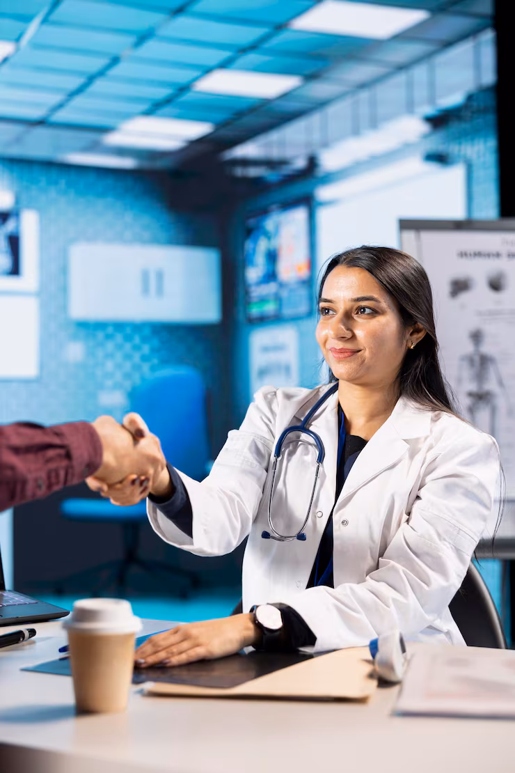 Female healthcare specialist greeting a patient for a medical check-up.
