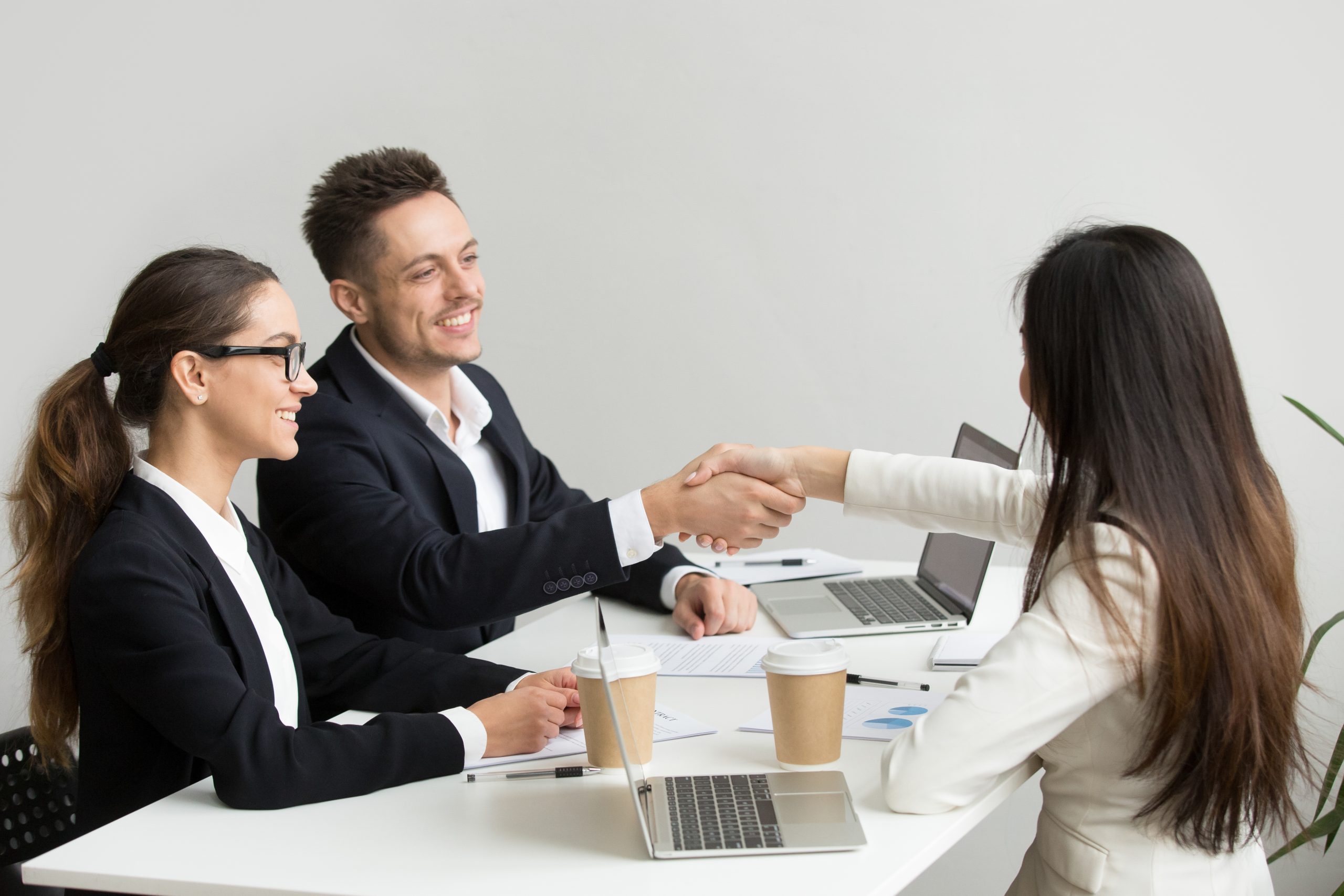Business partners shaking hands after a successful meeting.